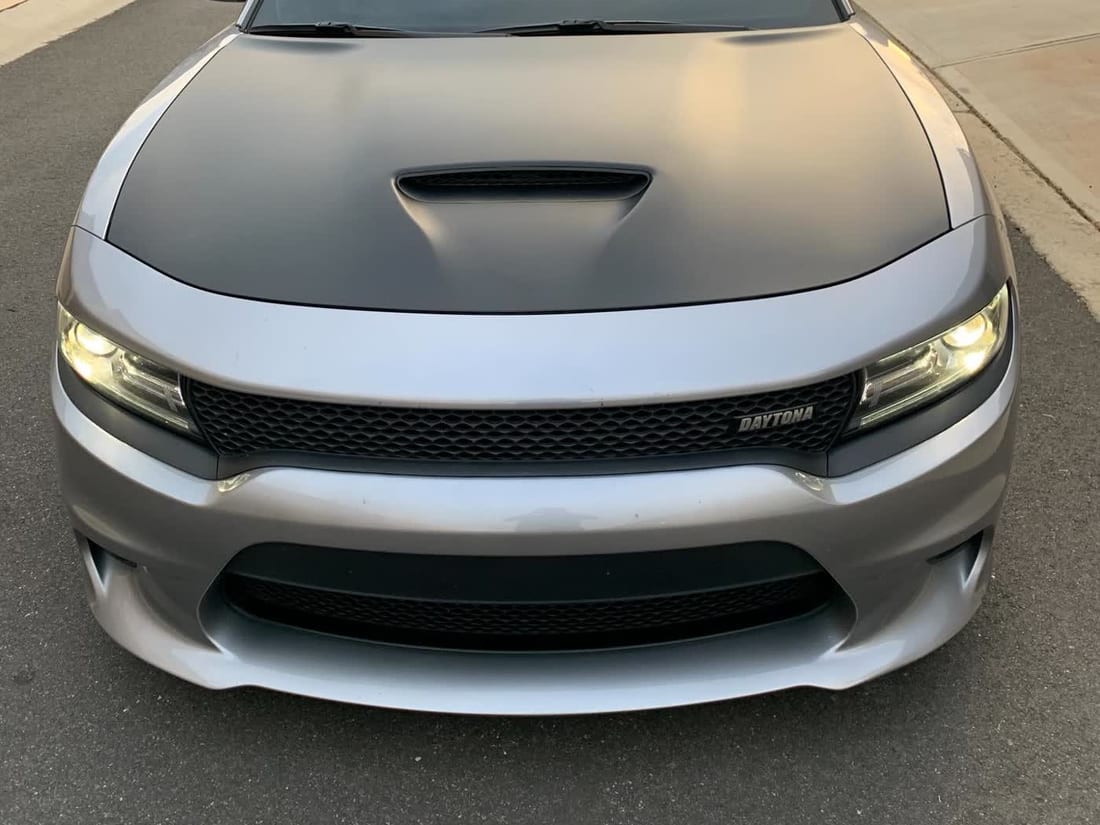 Dodge Charger with a silver body and matte black two-tone hood